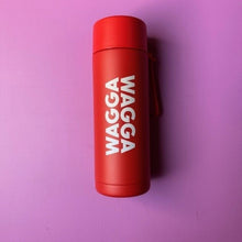 Load image into Gallery viewer, Red thermos with 'WAGGA' text on a purple background
