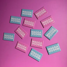 Load image into Gallery viewer, Multiple 'WAGGA WAGGA magnets on a pink background
