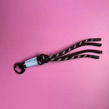Load image into Gallery viewer, Brown braided keychain with a blue tag 
