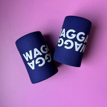 Load image into Gallery viewer, Two navy blue can coolers with white 'WAGGA' text, displayed on a solid pink background.
